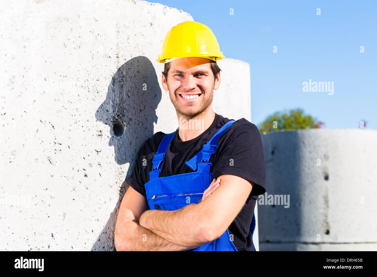 Pride builder standing on construction or building site with sewage or ...