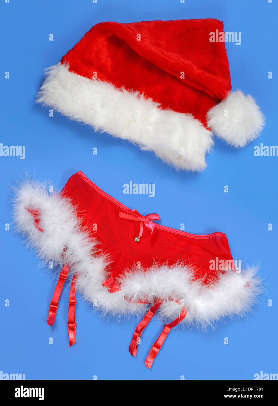 Red fluffy Christmas women sexy skirt and a hat romantic lingerie with white fur Isolated on blue background Stock Photo