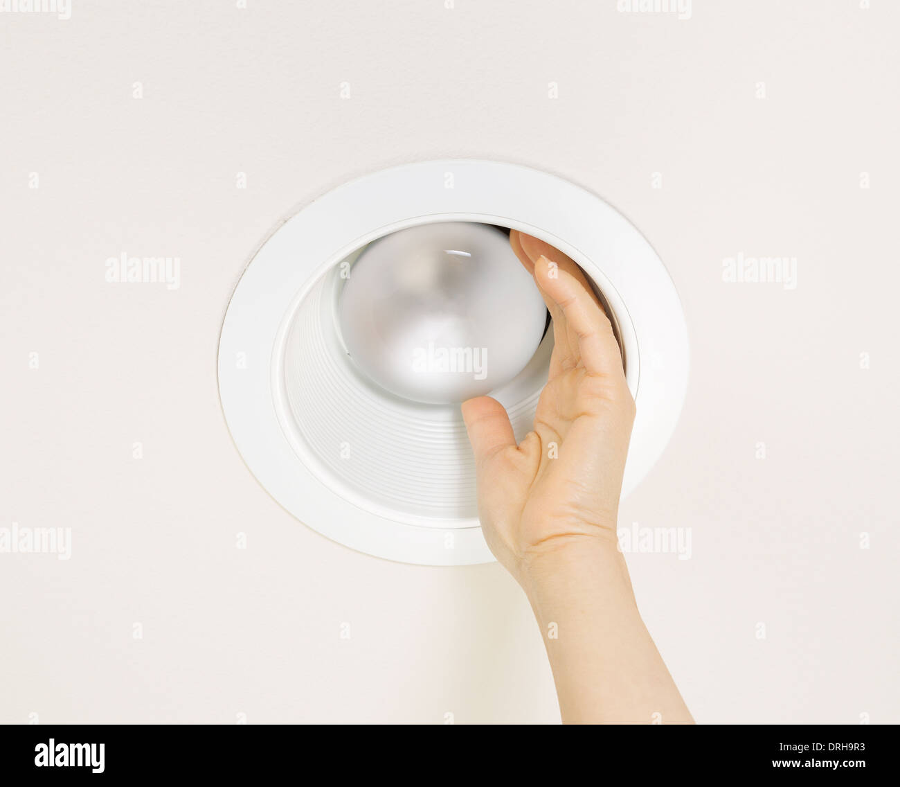 Photo of burned out flood light in recessed ceiling mount being removed