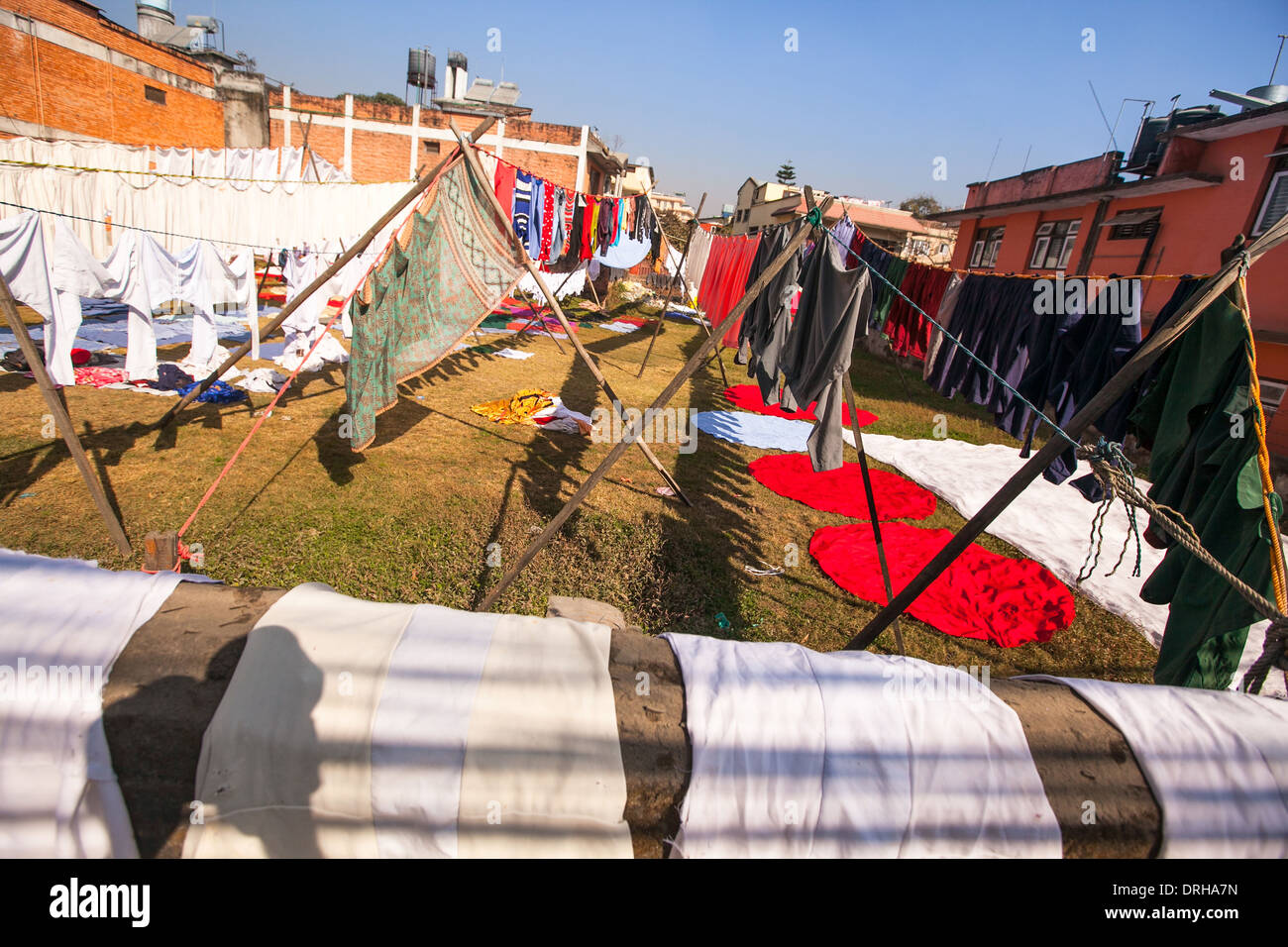 Colorful wet clothes washed. Laundry hanging in the open to dry in Kathmandu. Stock Photo