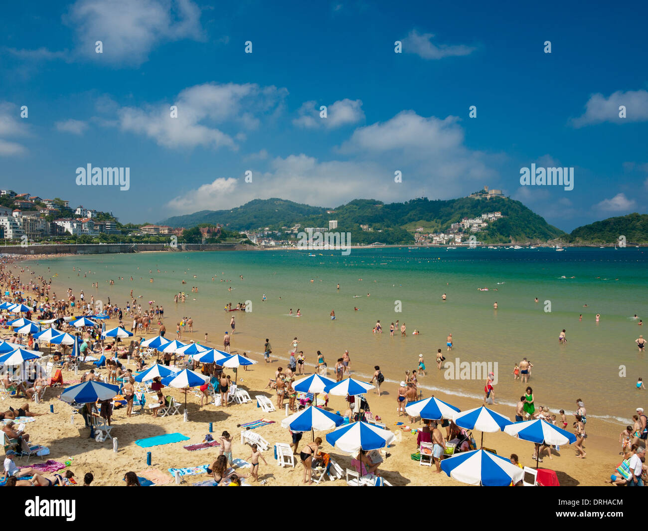 A view of the beautiful but crowded Playa de La Concha (Beach of La Concha) in San Sebastián (Donostia), Spain. Stock Photo