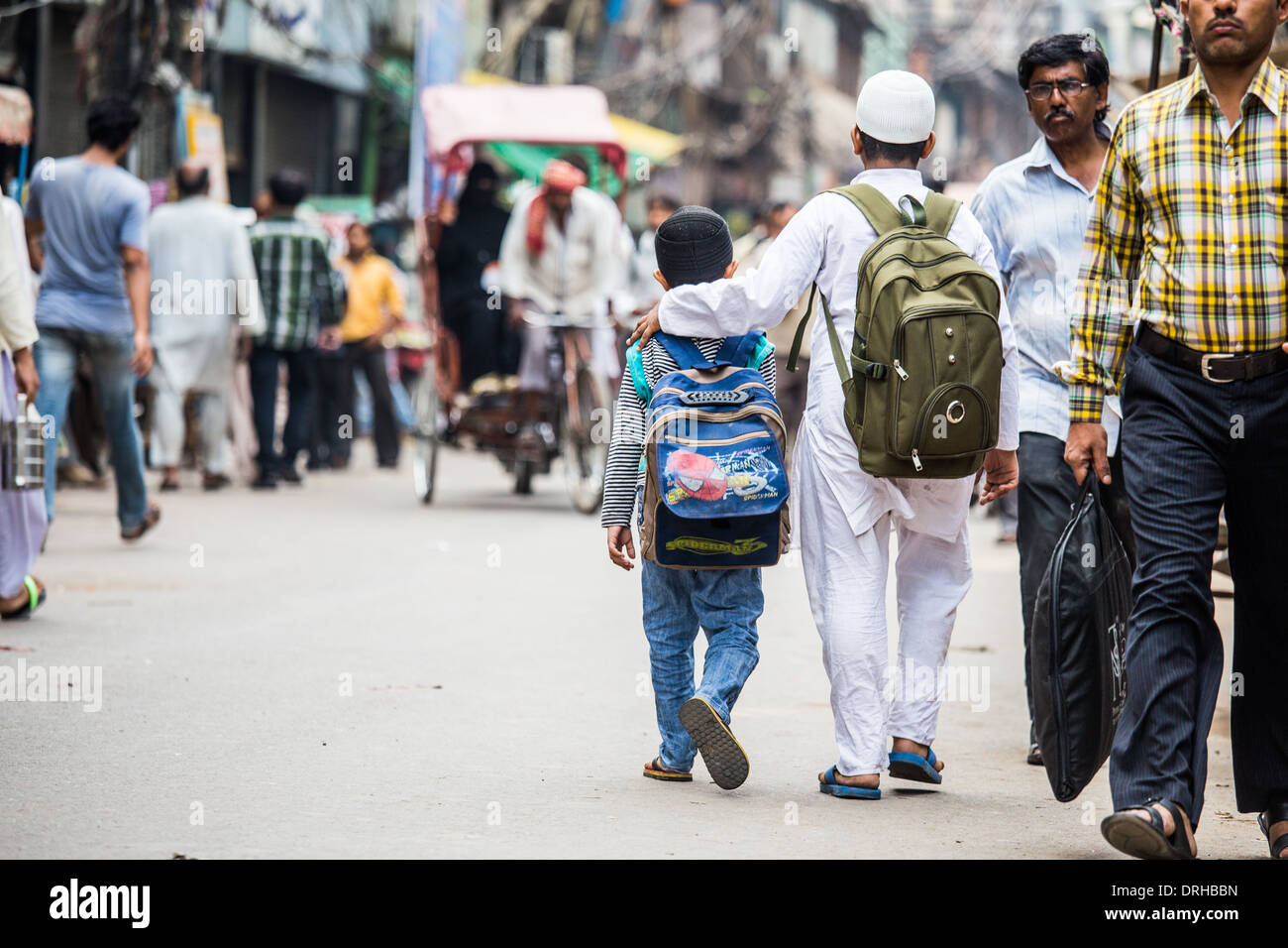 Muslim boys walking home from school in Old Delhi, India Stock Photo