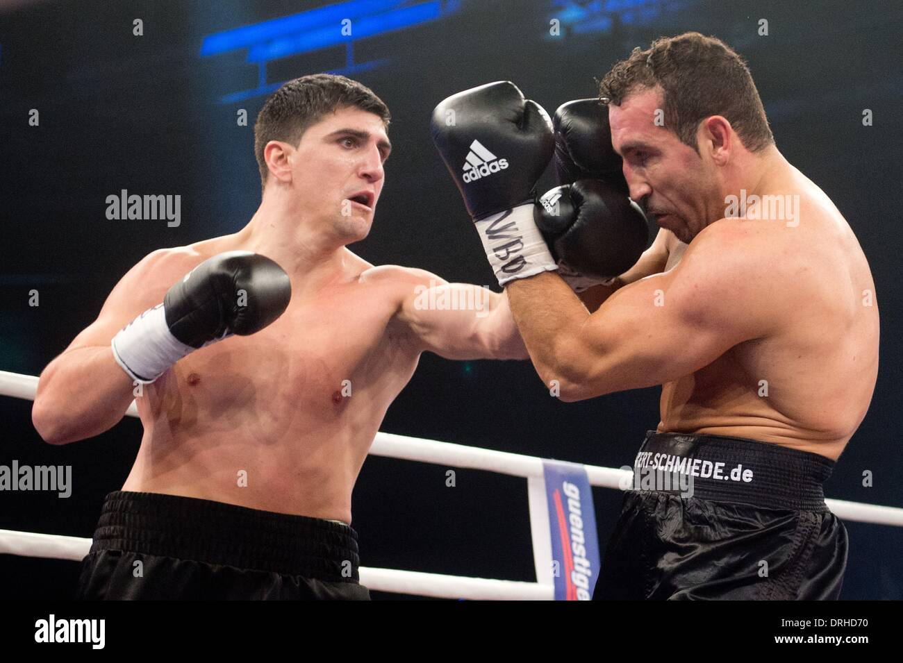 Stuttgart, Germany. 26th Jan, 2014. German WBO champion Marco Huck (L) in action against Firat Arslan during their World boxing Organization (WBO) Cruiserweight Championship match at Schleyer Hall in Stuttgart, Germany, 26 January 2014. Huck won against challenger Firat Arslan by technical k.o. in the sixth round. Photo: SEBASTIAN KAHNERT/dpa/Alamy Live News Stock Photo
