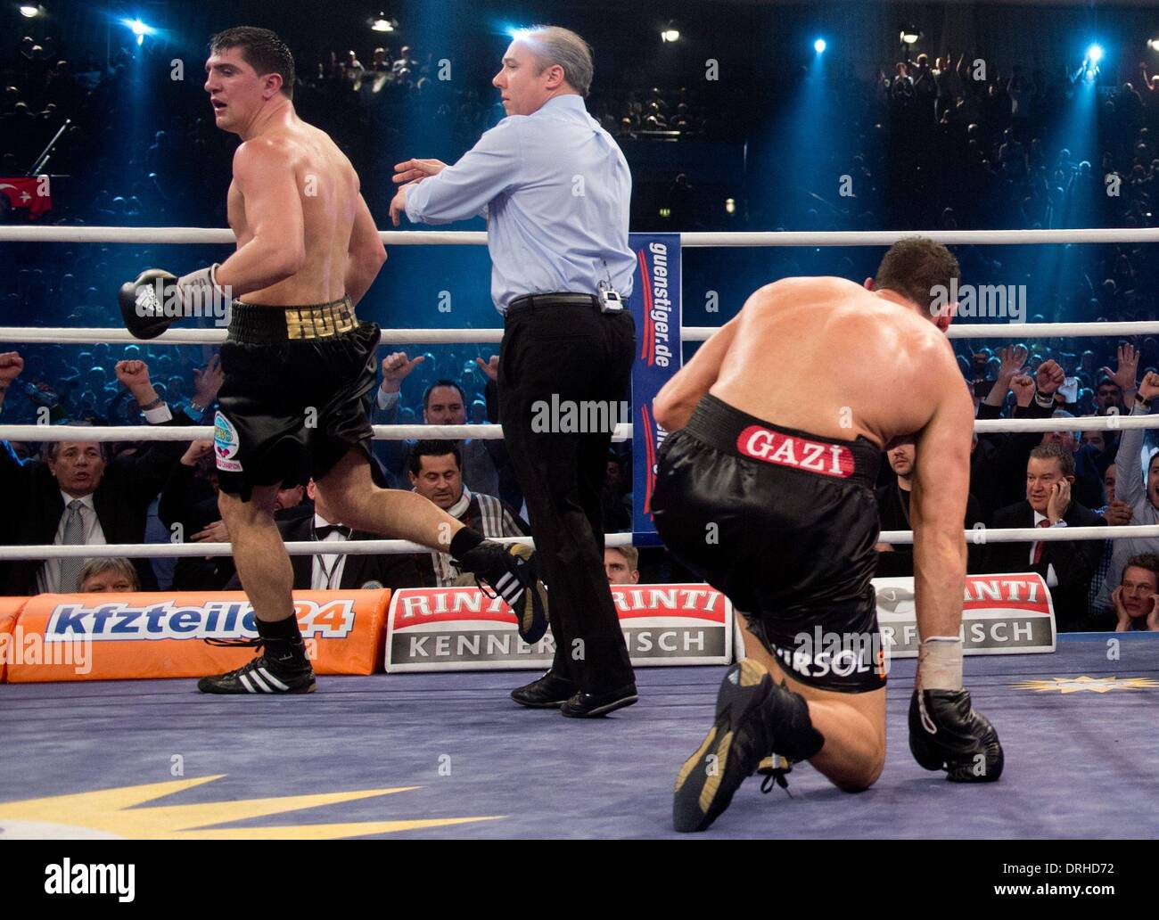 Stuttgart, Germany. 26th Jan, 2014. German WBO champion Marco Huck (L) in action against Firat Arslan who kneels on the floor (R) during their World boxing Organization (WBO) Cruiserweight Championship match at Schleyer Hall in Stuttgart, Germany, 26 January 2014. Huck won against challenger Firat Arslan by technical k.o. in the sixth round. Photo: SEBASTIAN KAHNERT/dpa/Alamy Live News Stock Photo