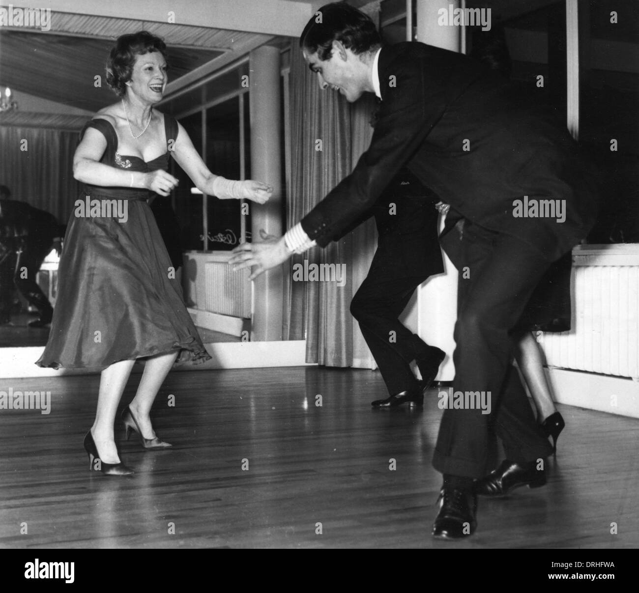 Anna Neagle dancing the twist with Grenville Collins Stock Photo