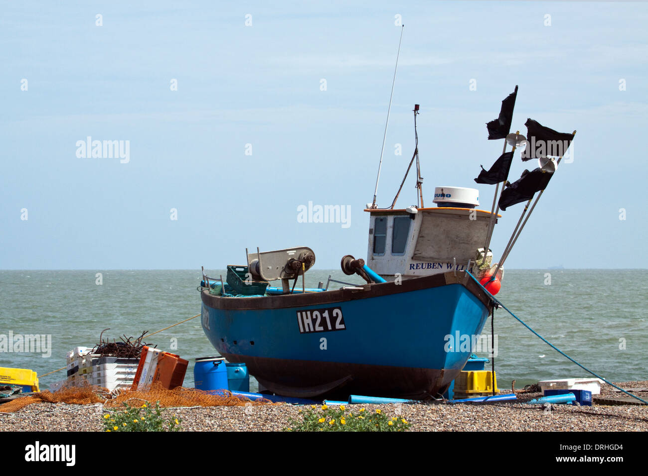 Fishing vessel IH212 on the beach at Aldeburgh, Suffolk with fishing paraphenalia around it Stock Photo