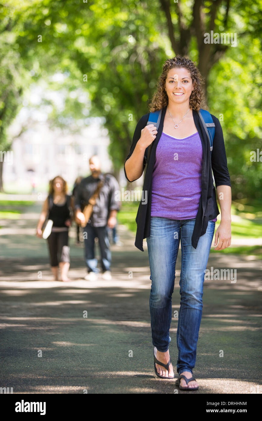 Confident Female Student Walking On Campus Road Stock Photo - Alamy
