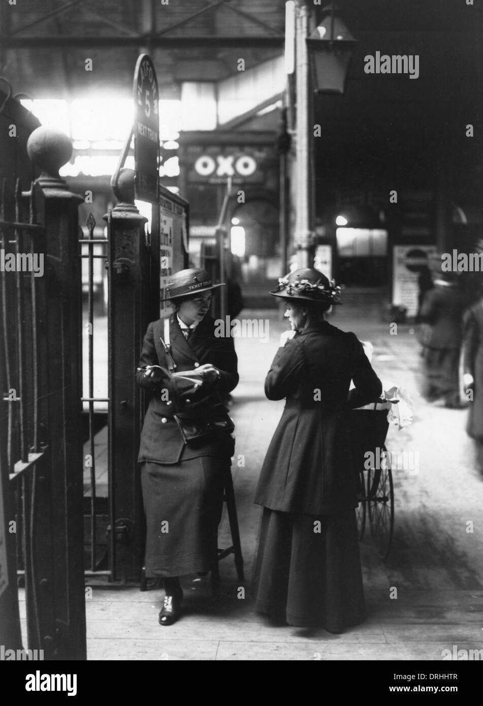 A female ticket collector at platform five in a London train Stock Photo