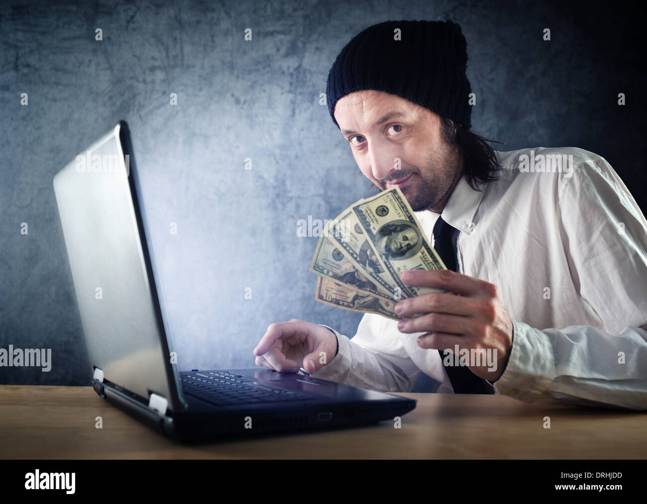 Making money online, businessman with laptop computer is earning money over internet. Stock Photo