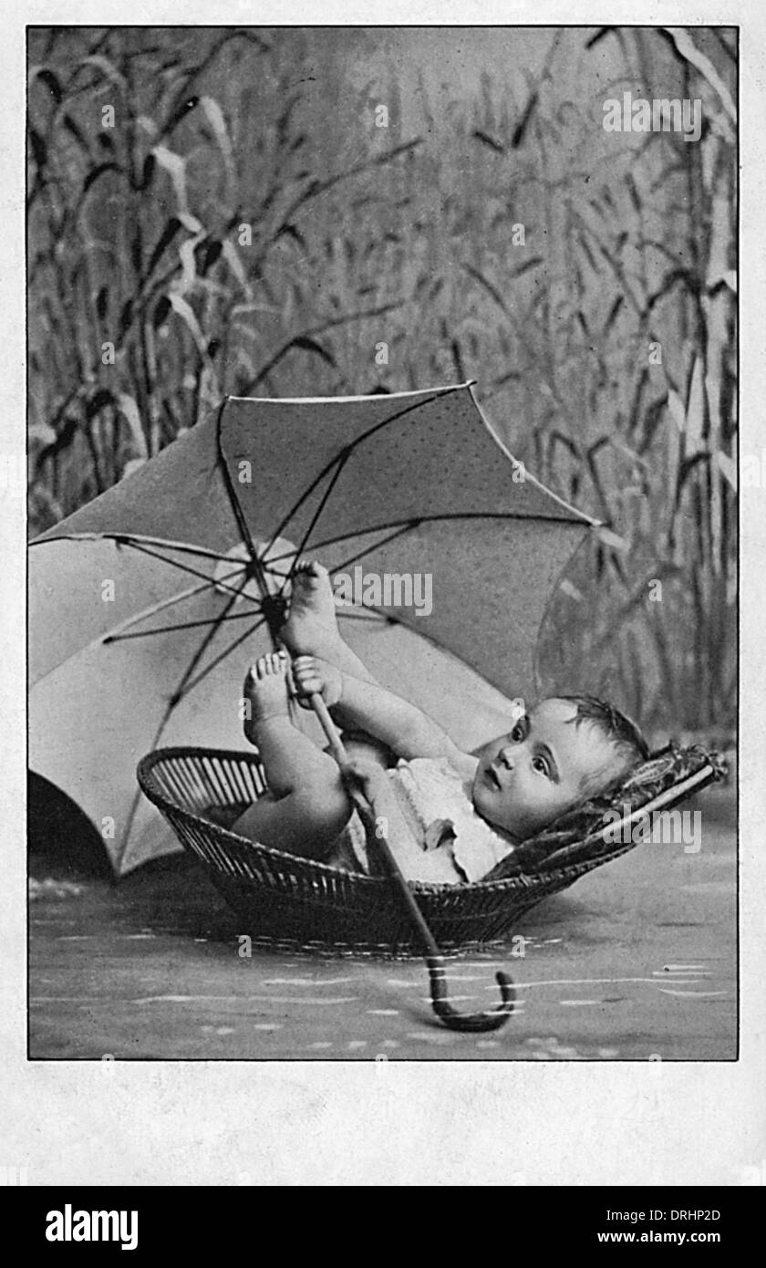 Small Baby boy in a Moses Basket amid the reeds Stock Photo