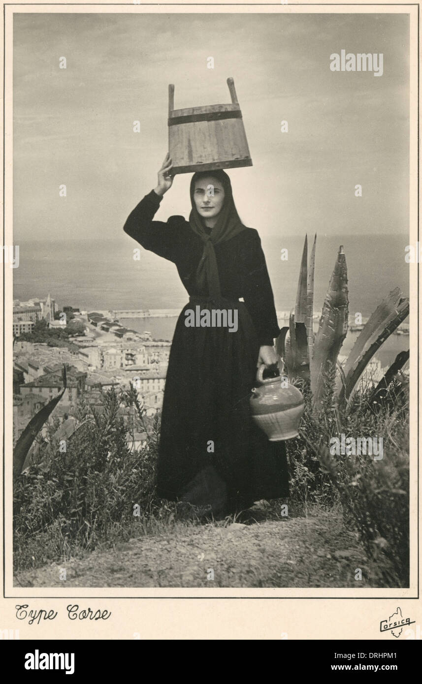 Corsica - Corsican woman with bucket on her head Stock Photo