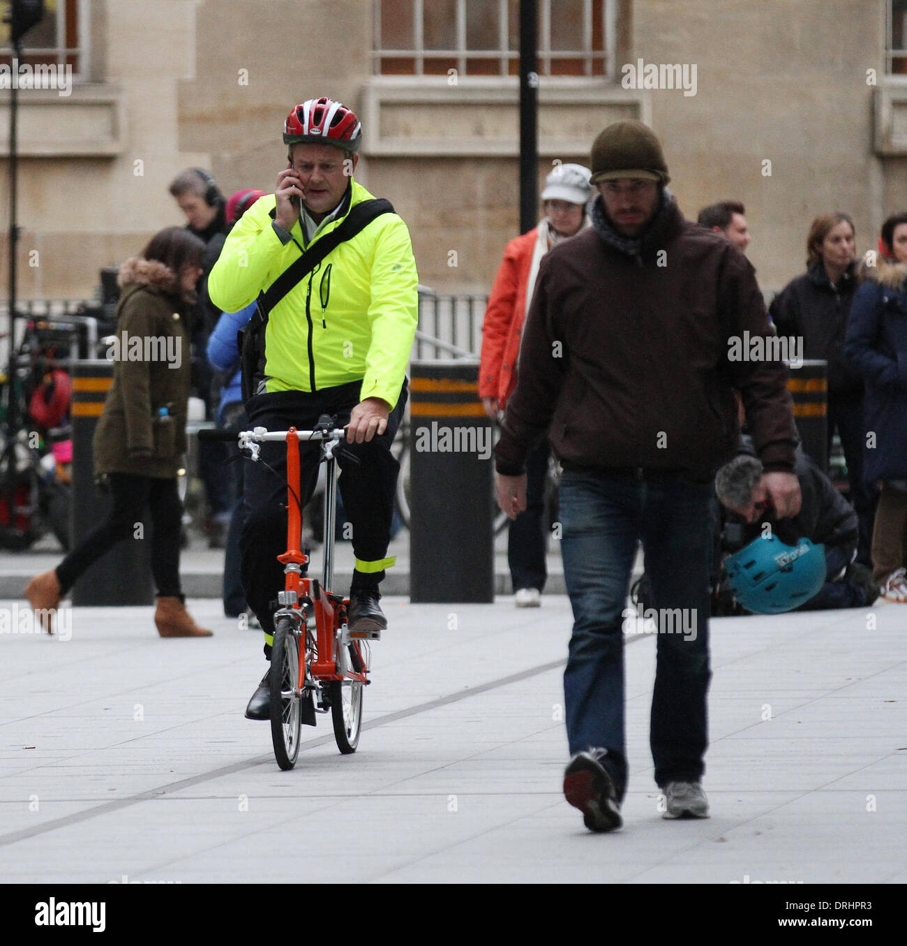 London, UK, 26th January 2014. Hugh Bonneville riding a bicycle while filming at the BBC, Broadcasting House in London, UK © Sim Stock Photo