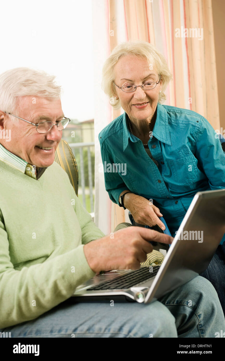 Senior couple using laptop in nursing home, Bavaria, Germany Stock Photo