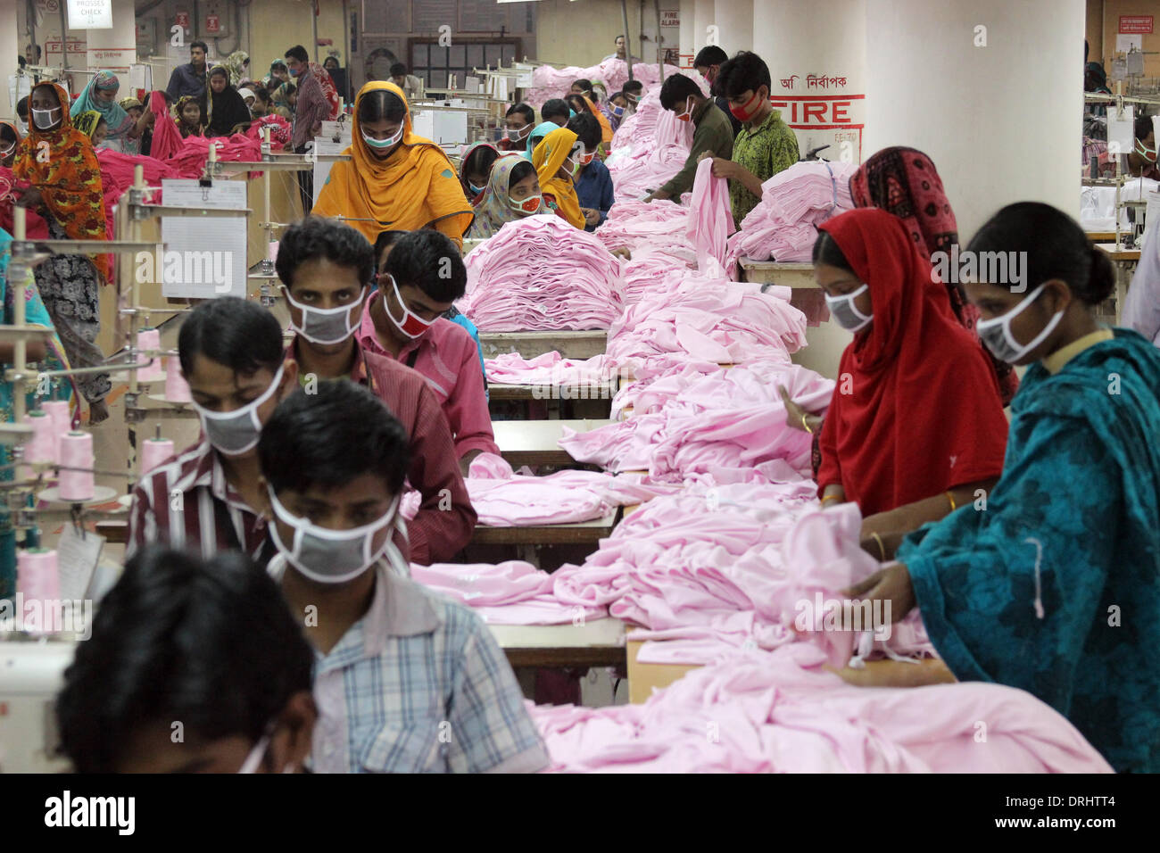 Dhaka, Bangladesh. 03rd Jan, 2014. Women and men work in the textile  factory 'One Composite Mills' in Gazipur, a suburb of Dhaka, Bangladesh, 03  January 2014. They make products for German mail-order