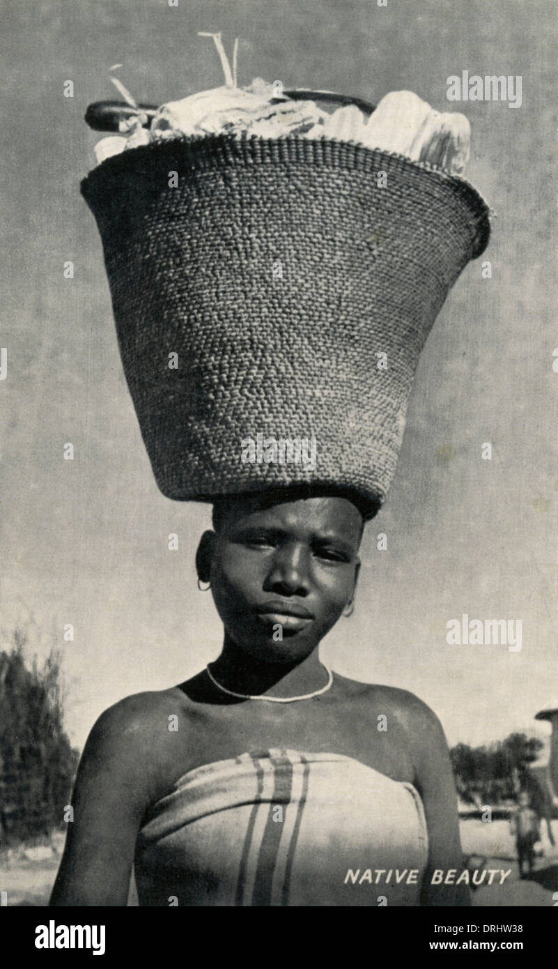 Africa woman carrying maize on her head Stock Photo