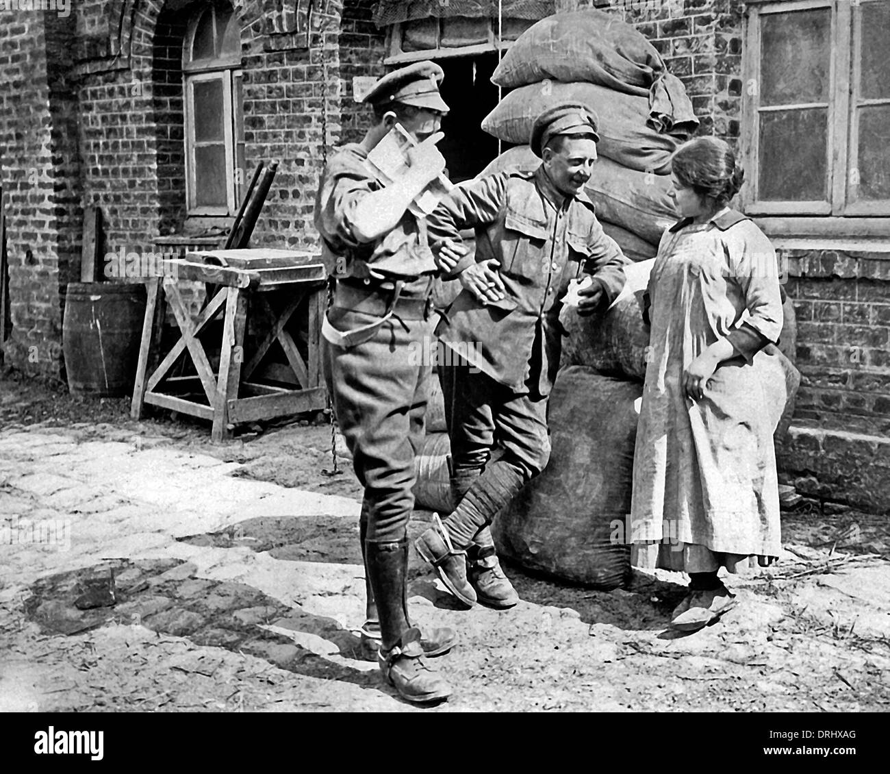 Two British soldiers chat with miller's daughter, WW1 Stock Photo