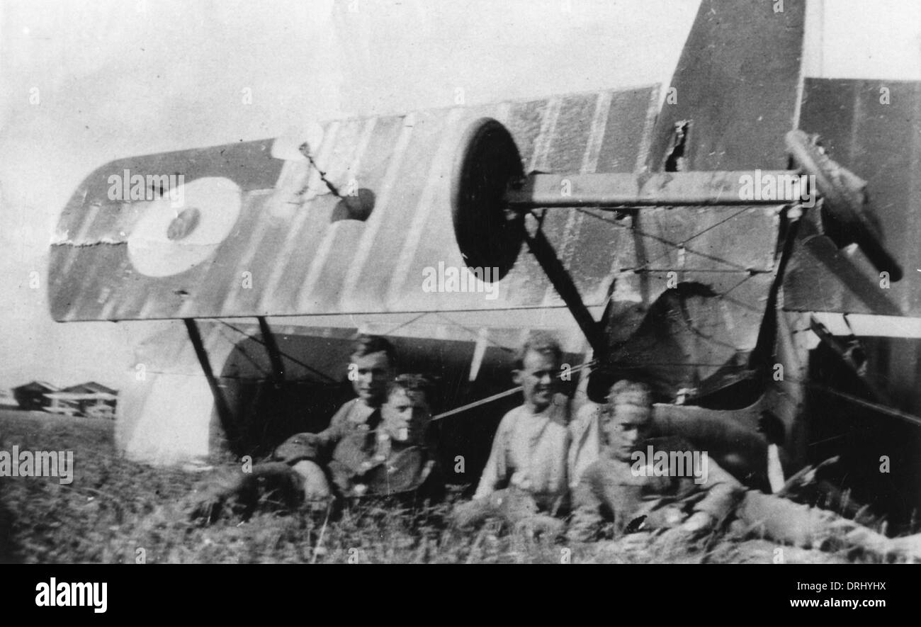 Four men with upturned biplane in field, WW1 Stock Photo