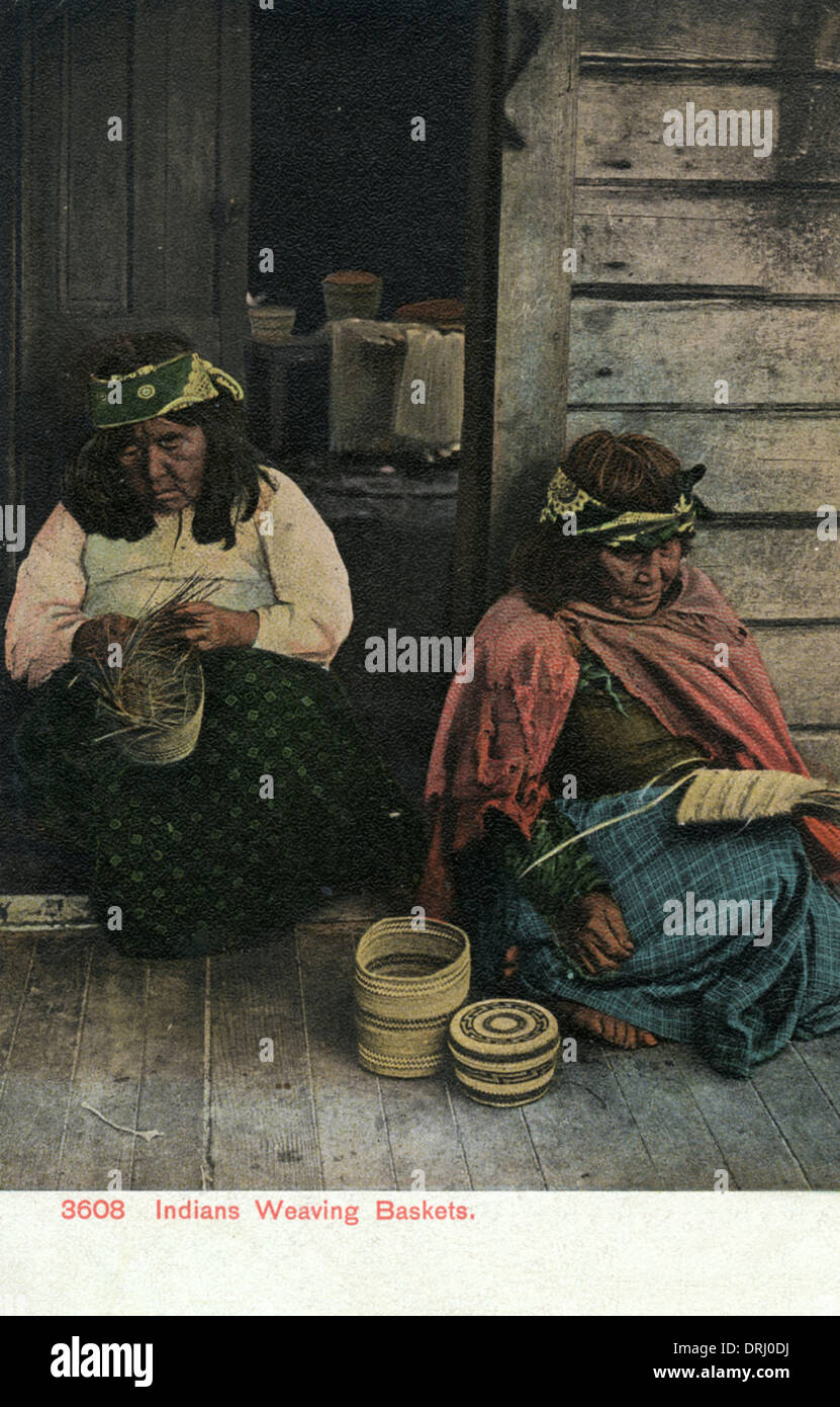 Elderly Native American women weaving baskets Stock Photo