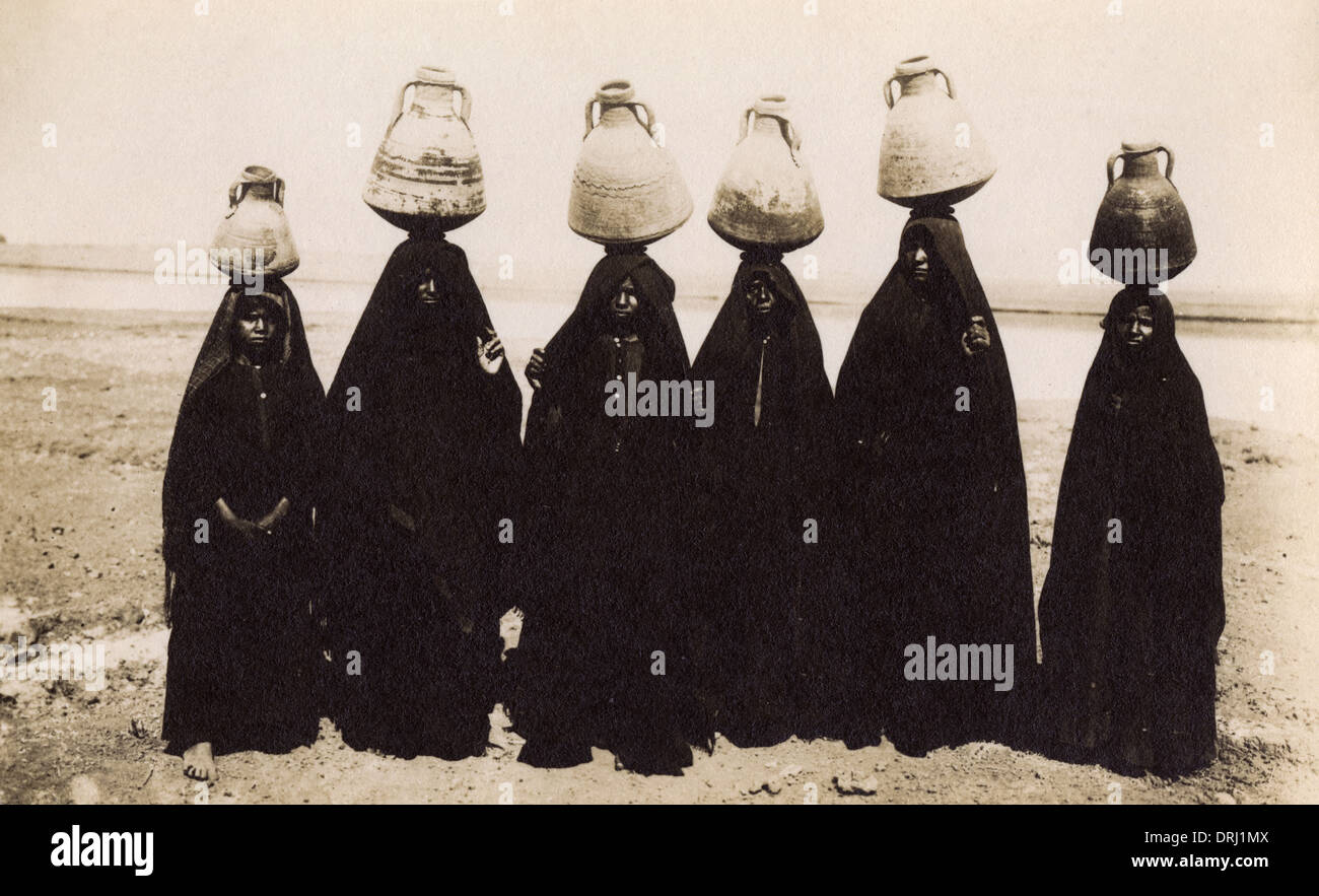 East African women with earthenware jars on their heads Stock Photo