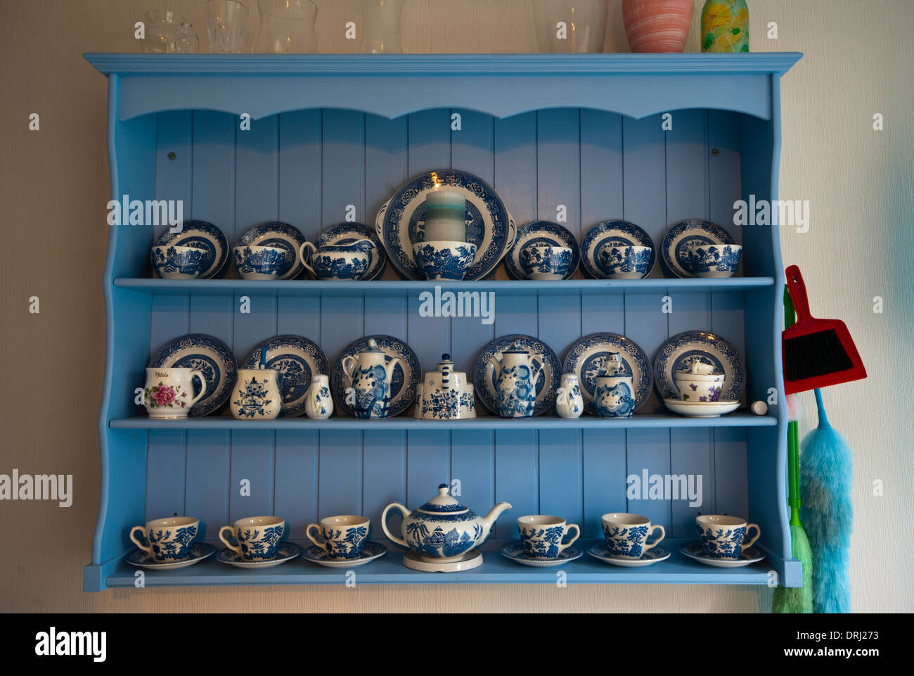 Wooden Wall Display Unit With Blue and White Crockery Stock Photo