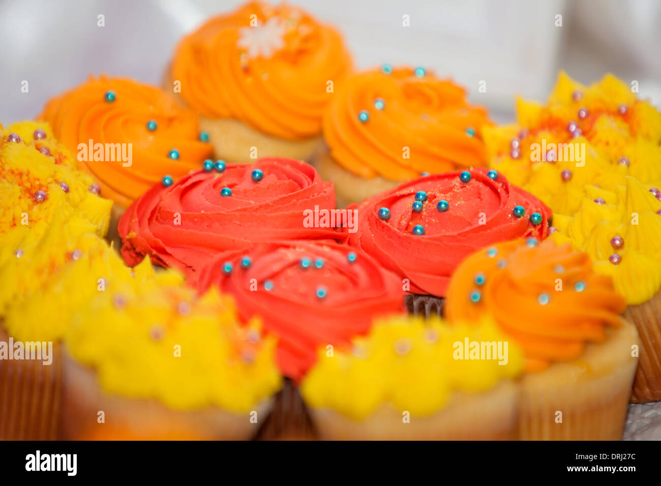 Creamy colored cupcakes with blue and pink sprinkles Stock Photo Alamy
