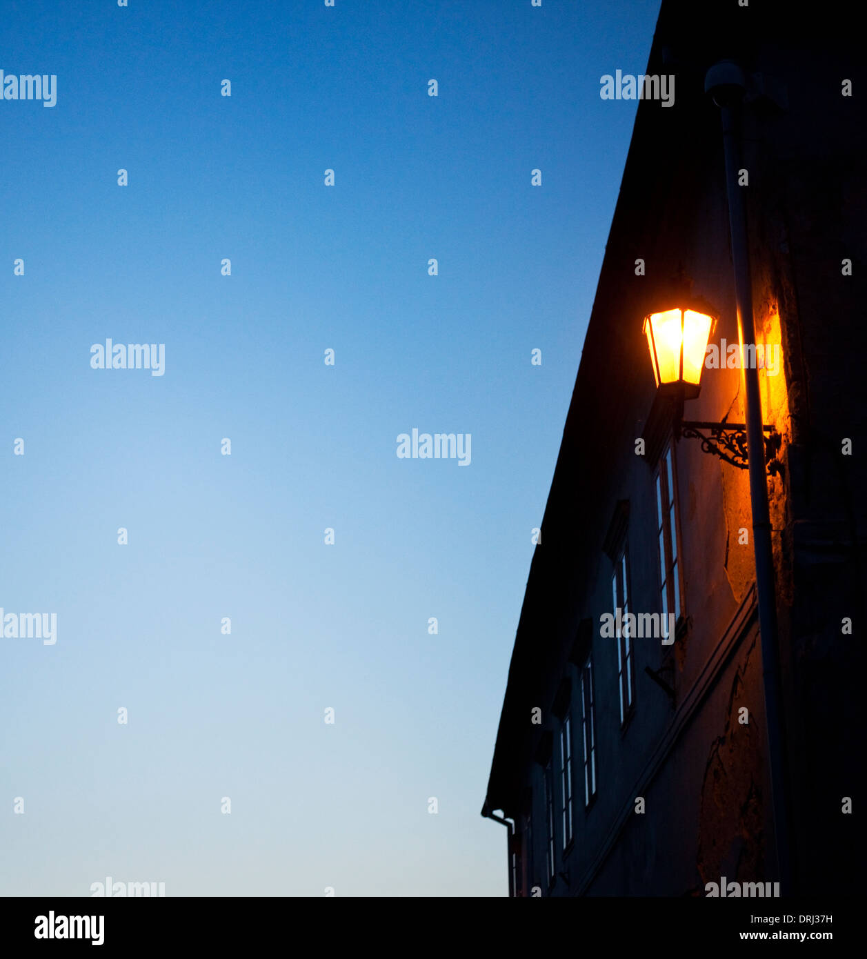 House facade with a lit exterior lighting Stock Photo