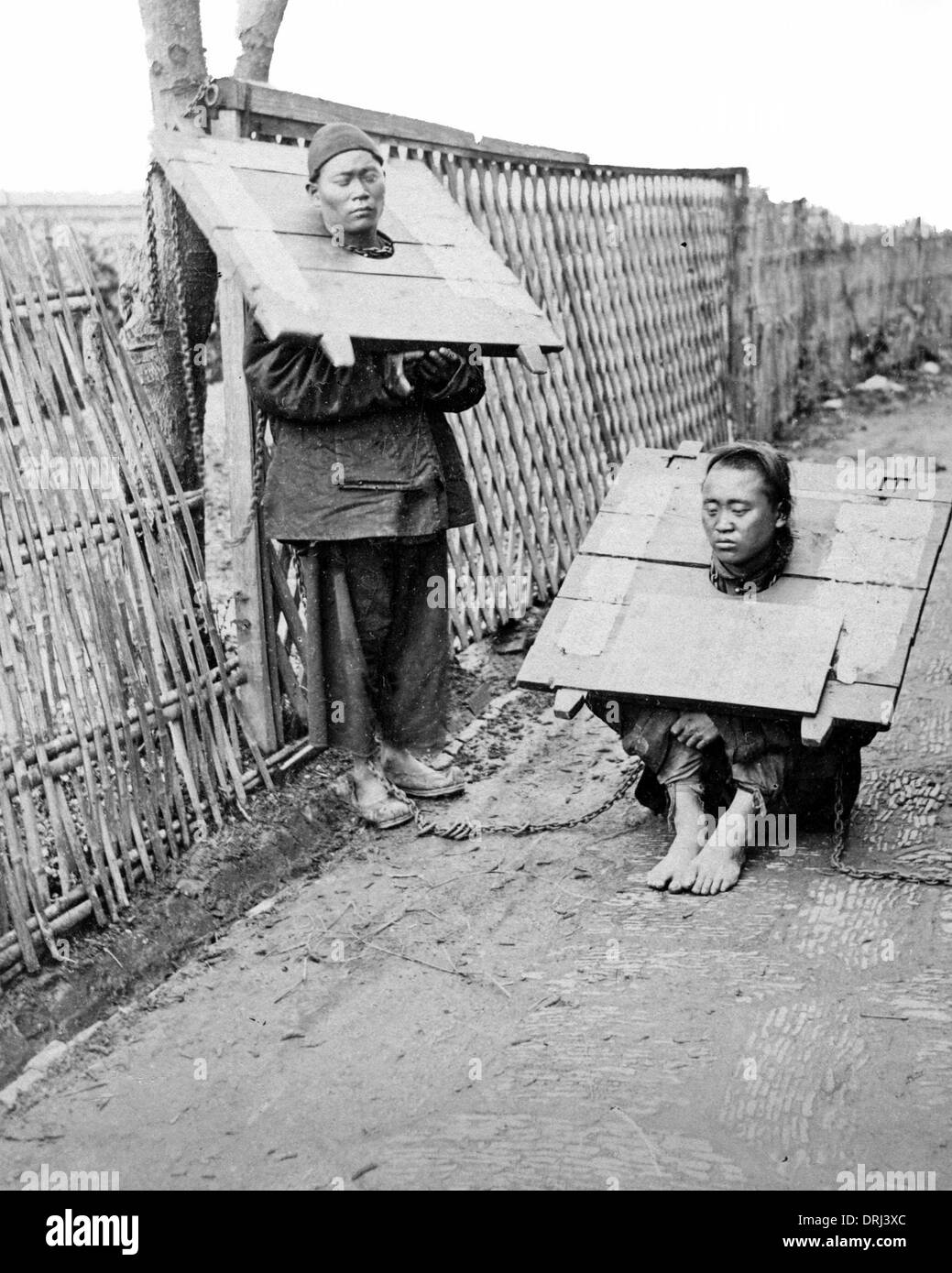 Two prisoners wearing the Cangue, China Stock Photo