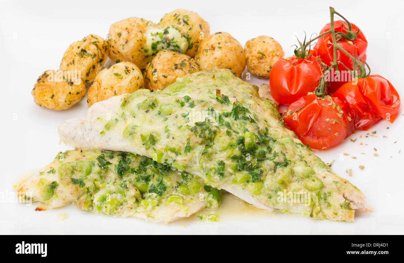 Fillets of Sea Bream served with a garnished coating of pea, creme fraiche and mint, new potatoes and grilled vine tomato Stock Photo