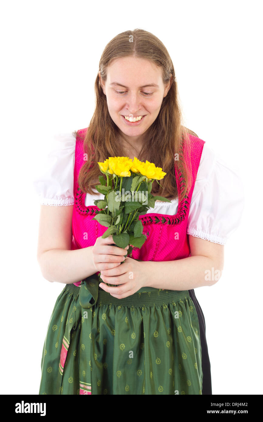 Beautiful woman in dirndl happy about these roses Stock Photo