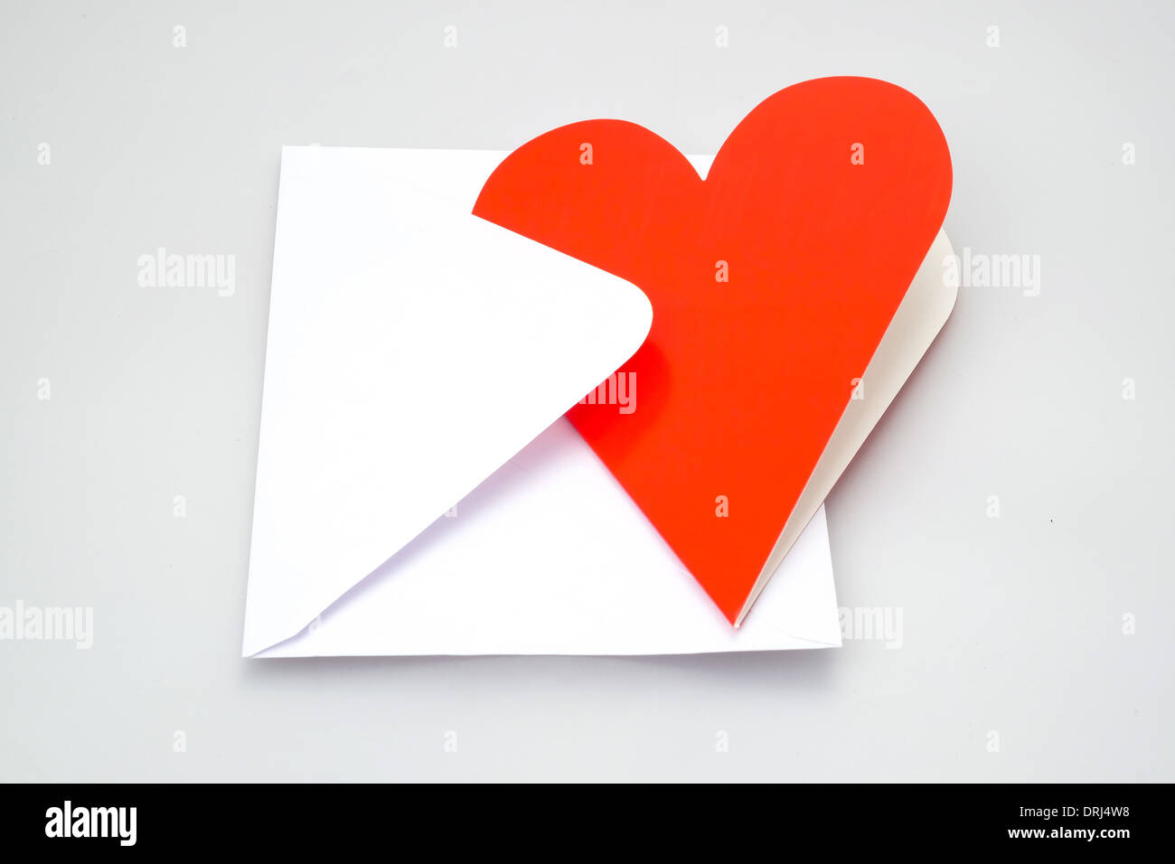 Perfect for a love letter, a heart shaped greeting card and envelope - studio shot with a white background Stock Photo