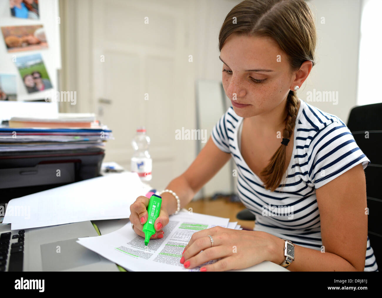 Student young woman student digs before laptop writes MR available Stock Photo