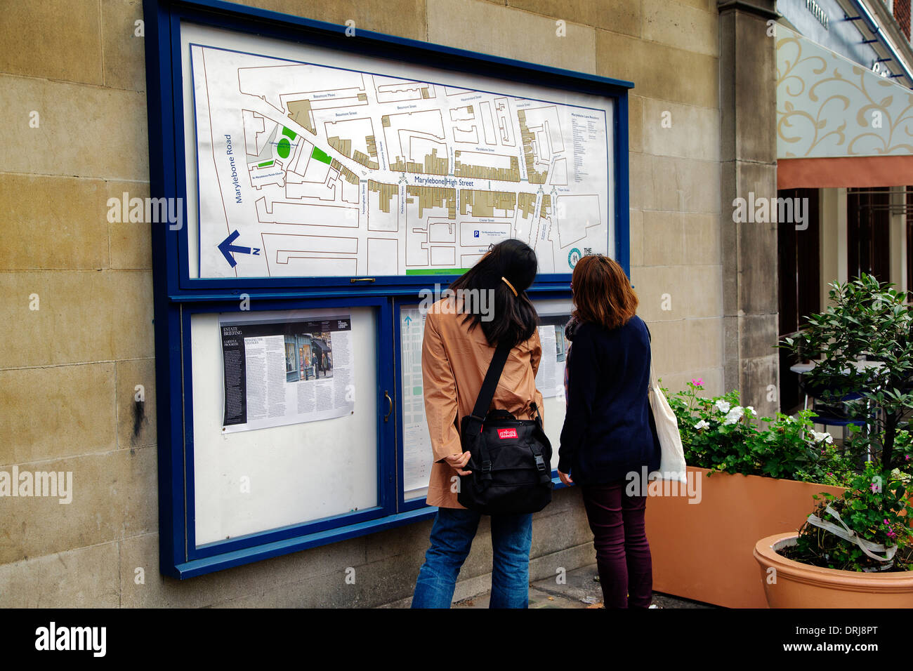 Couple studying Marylebone High Street Map, Marylebone, London, England, UK, Europe Stock Photo