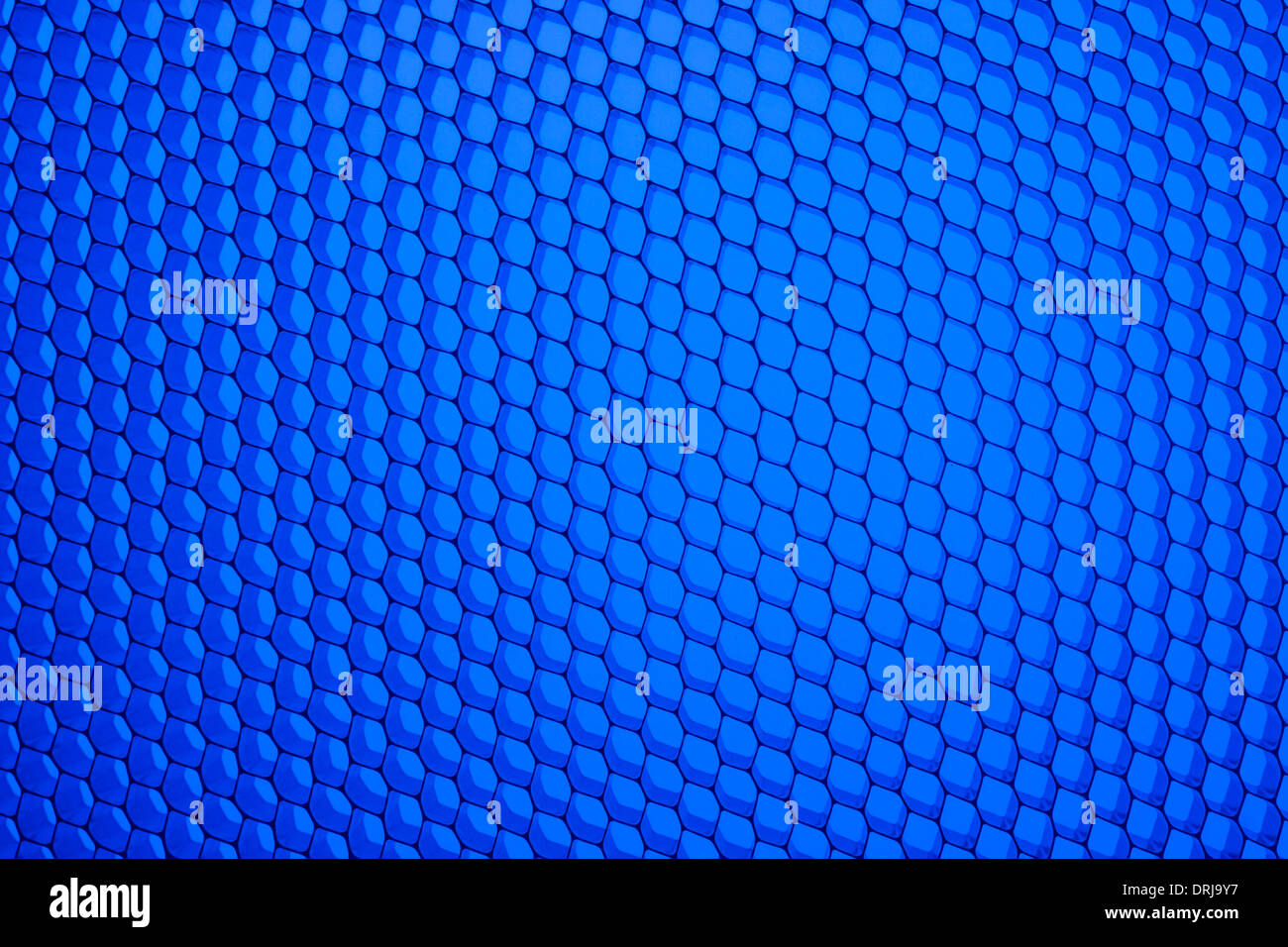 Honeycomb grid against blue background Stock Photo