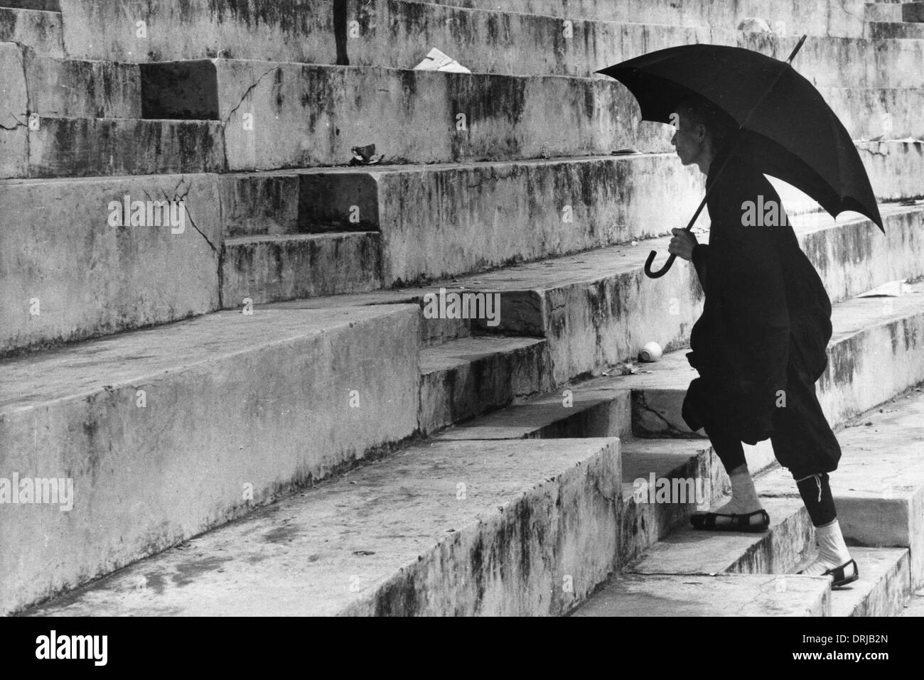 Man climbing steps in a stadium, Canton, China Stock Photo