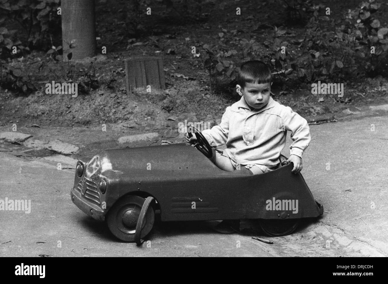 Little boy in toy car, Kiev, Ukraine Stock Photo