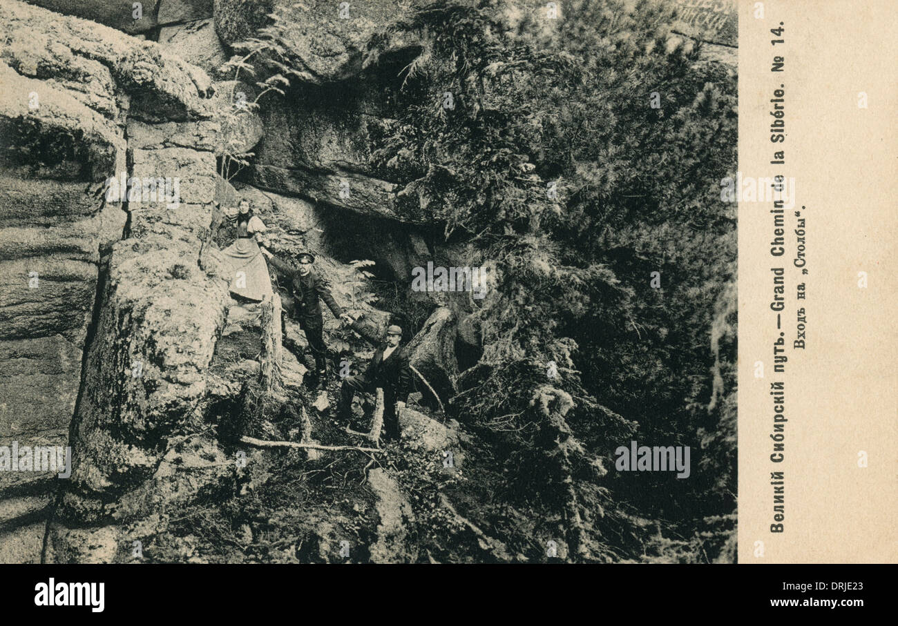People climbing large rock, Siberia, Russia Stock Photo Alamy