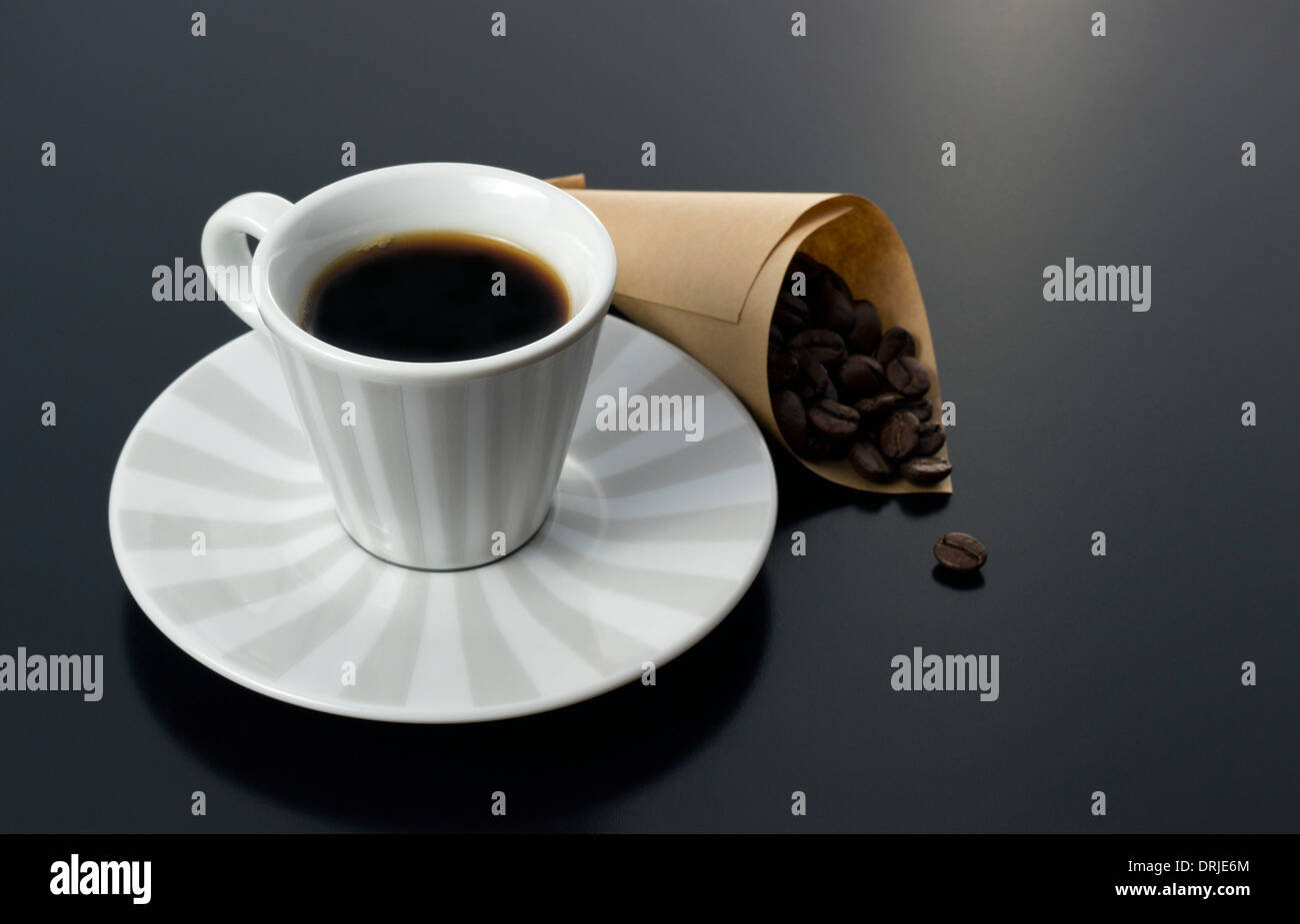 coffee cup with roasted beans on morning table Stock Photo