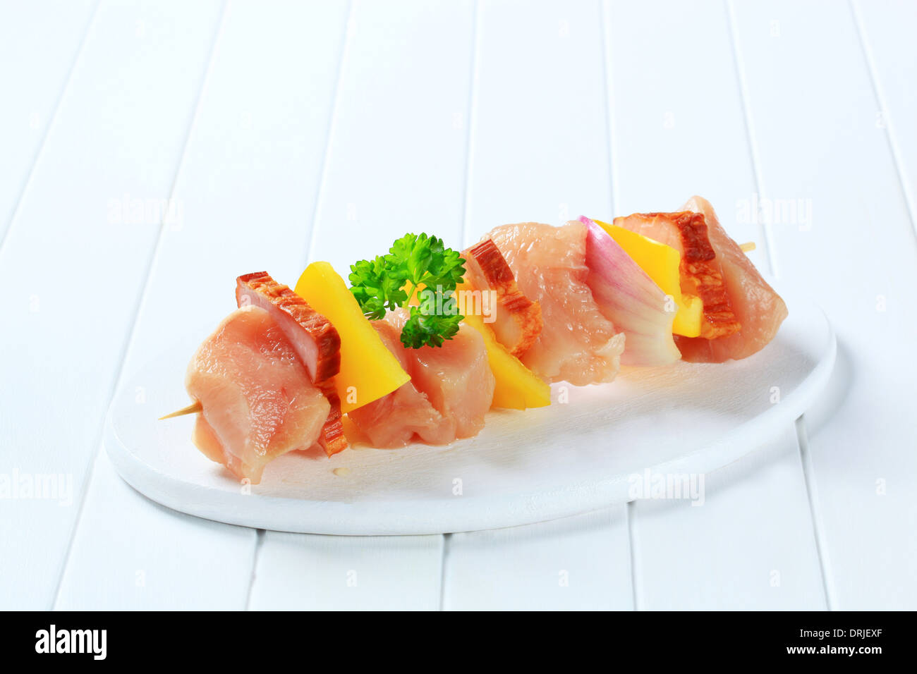 Raw chicken shish kebab with yellow pepper and bacon Stock Photo