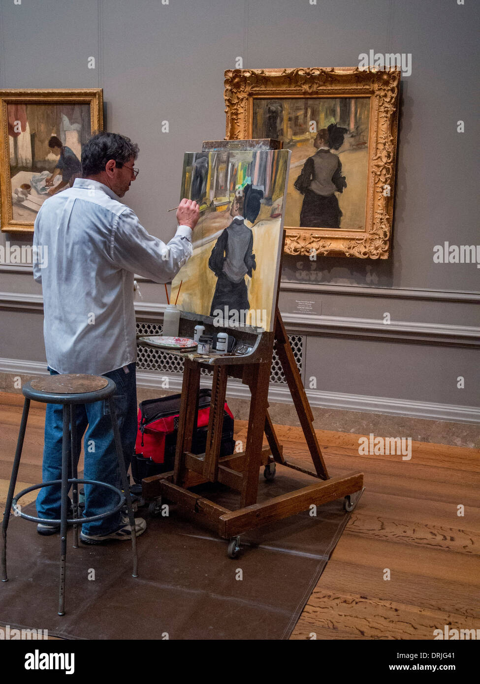 Working at easel in the National Gallery of Art in Washington D.C., an art student paints a copy of Edgar Degas. Stock Photo
