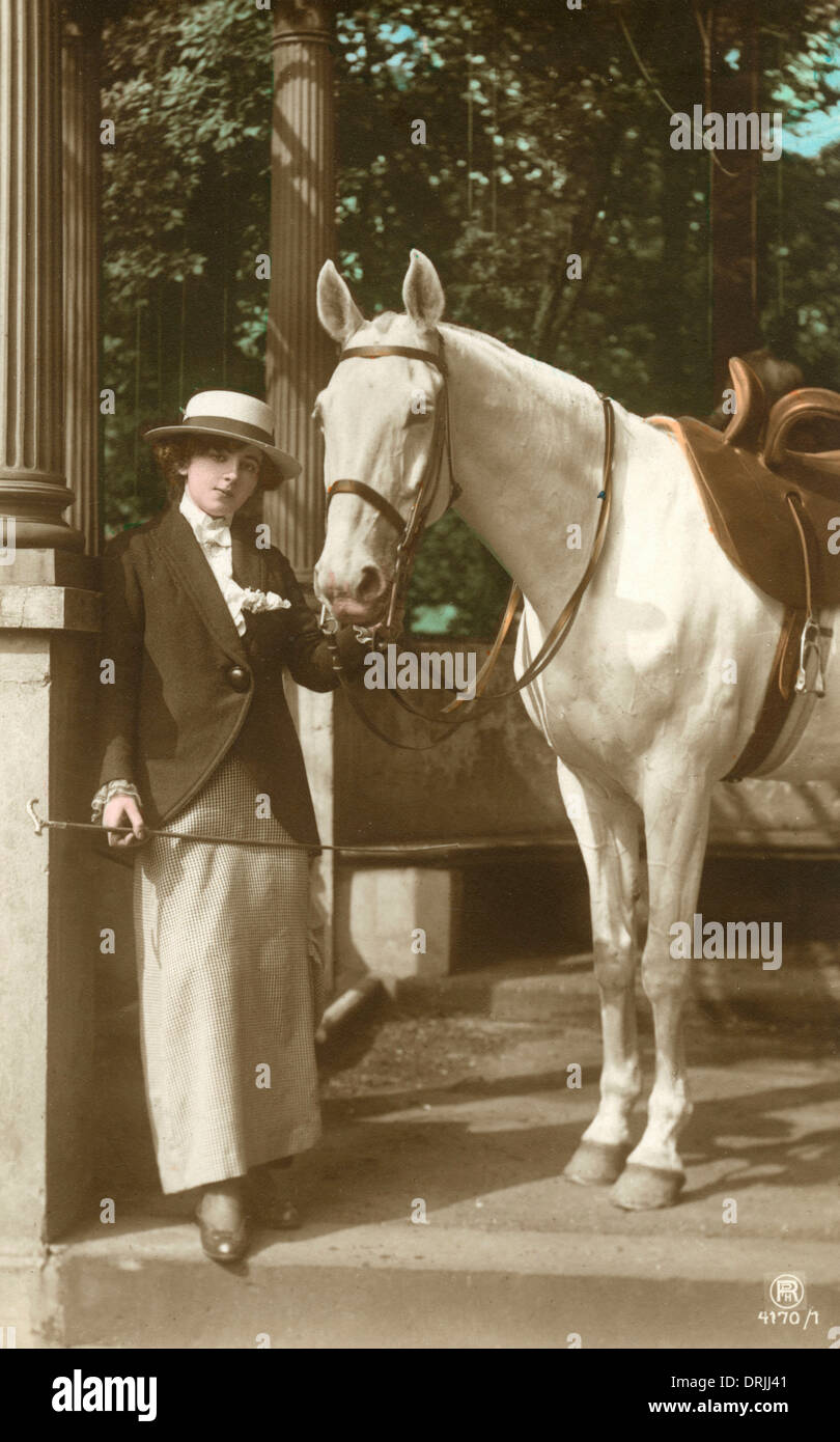 A young lady with her fine grey horse Stock Photo