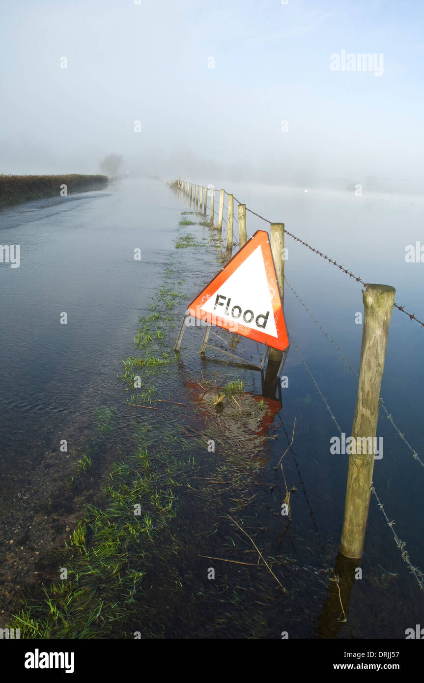 Flooded country road with warning sign Stock Photo - Alamy