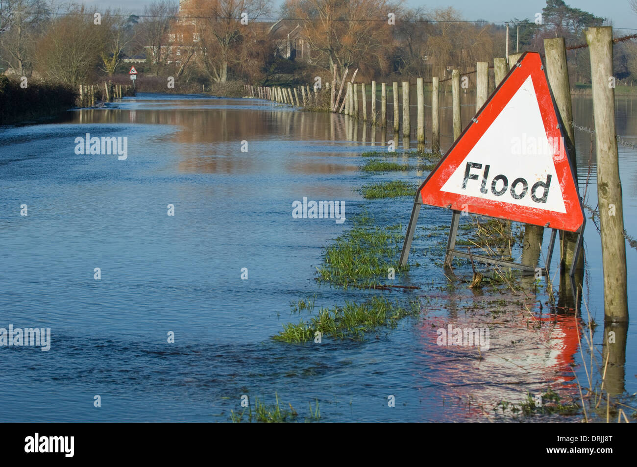 Flooded country road with warning sign Stock Photo - Alamy