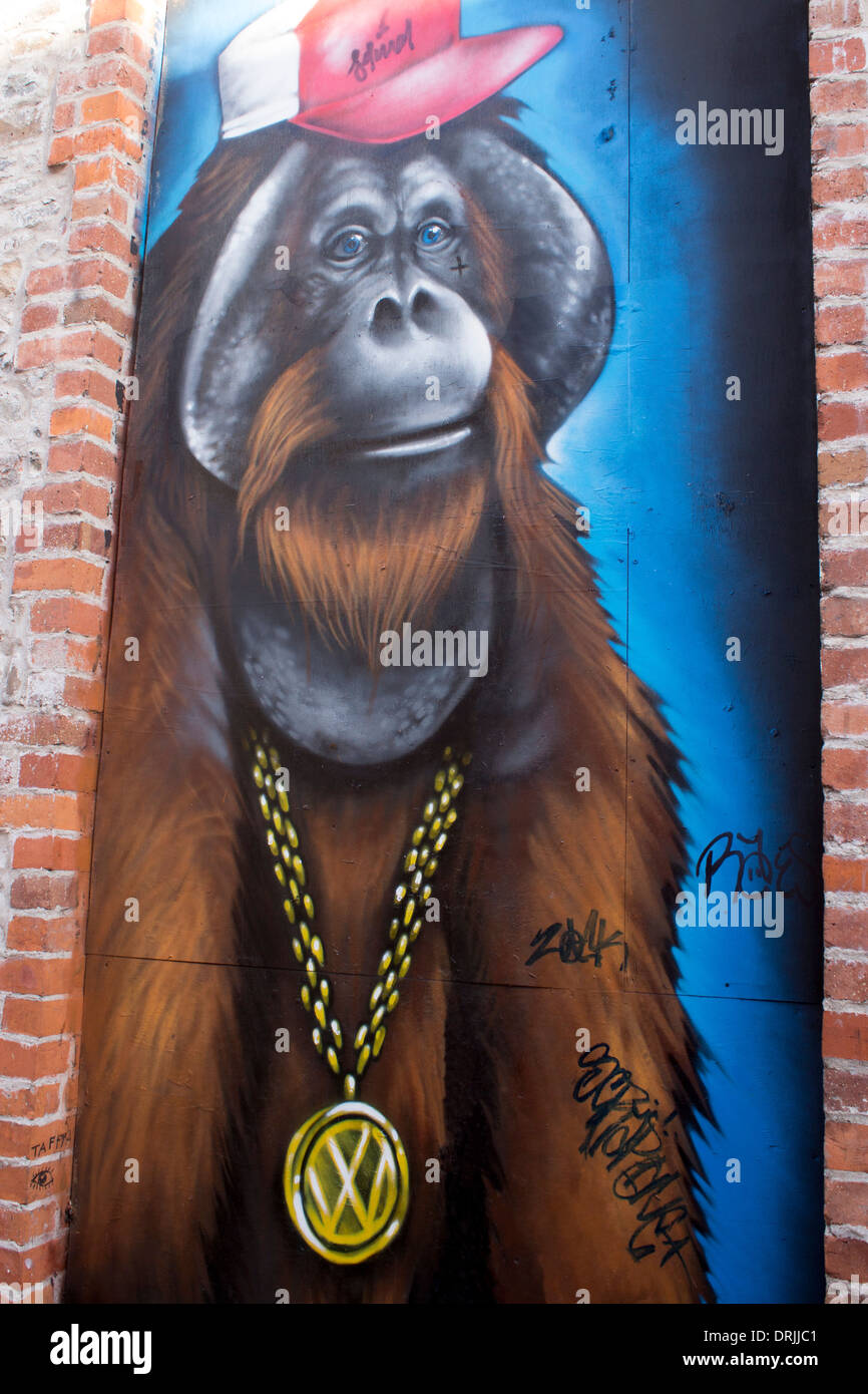 Wall painting mural artwork art of hip hop ape orangutan wearing VW Volkswagen car badge emblem Cardiff Wales UK Stock Photo