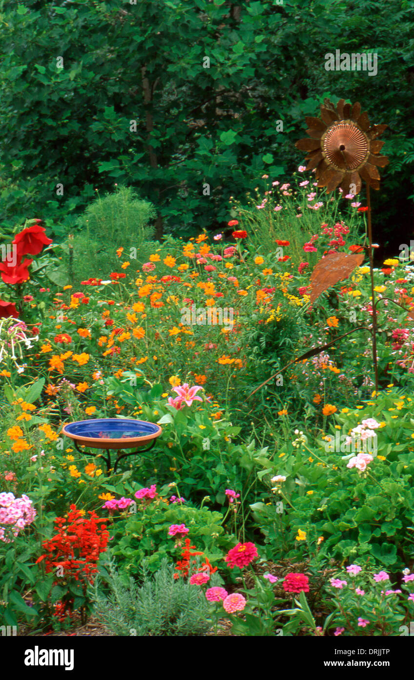 Garden art: unique copper sunflower in multi-colored summer garden, Missouri USA Stock Photo