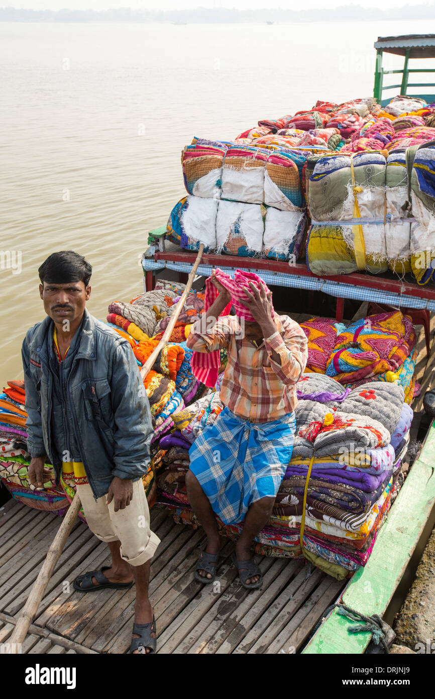 Boats carrying people and goods in the Sunderbans, a low lying area of the Ganges Delta in Eastern India, Stock Photo