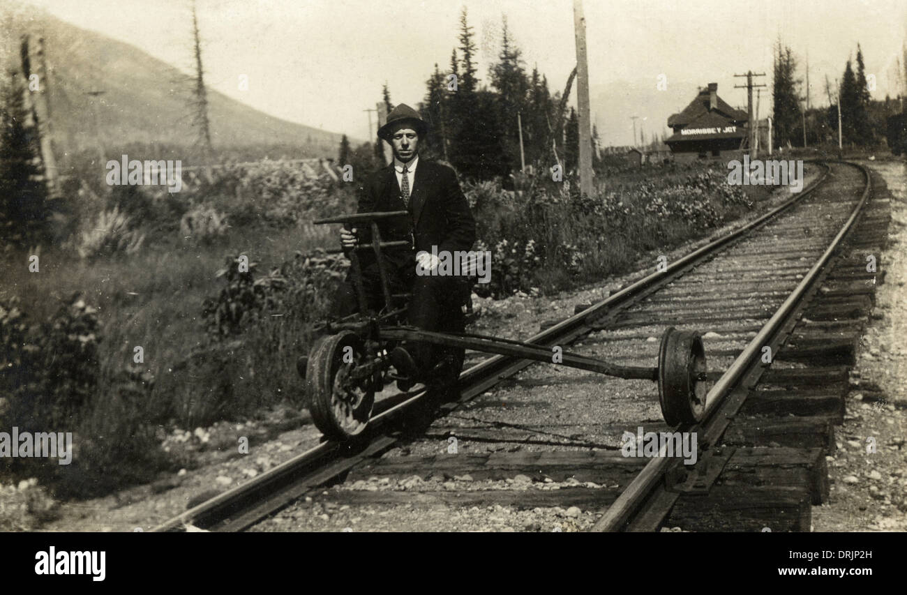 A man sitting on part of a modified railway suspension Stock Photo