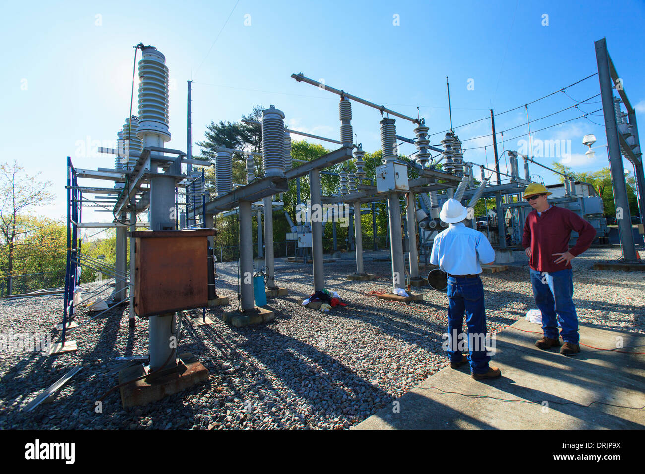 Power engineers reviewing maintenance at high voltage power