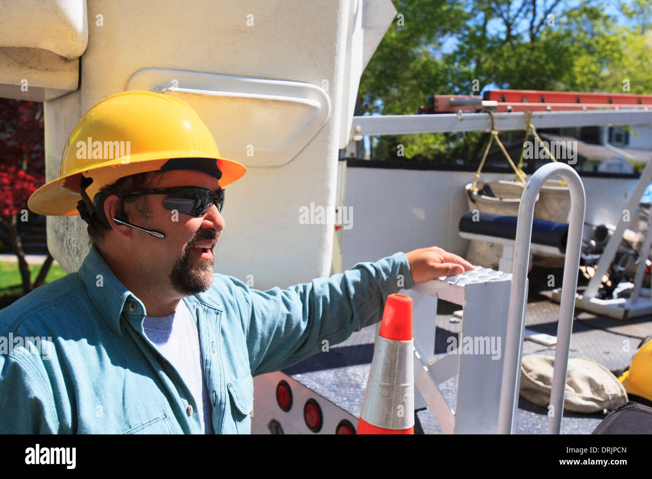 Power engineer with lift bucket truck to work on power lines, Braintree