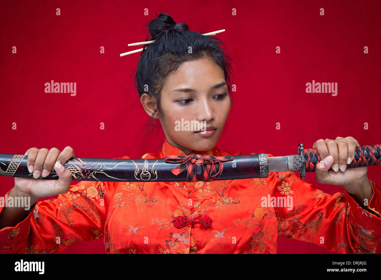 Asian woman holding a sword Stock Photo