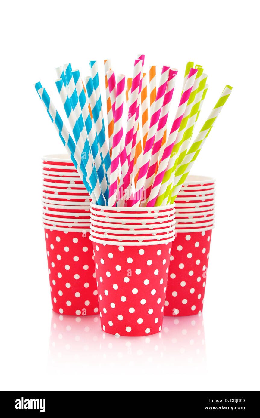 Colorful paper cups and striped straws for birthday party isolated on ...